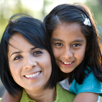 A mother and her daughter smiling