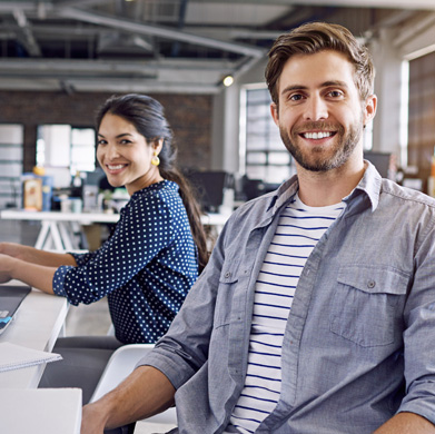 Two small-business coworkers at their desks